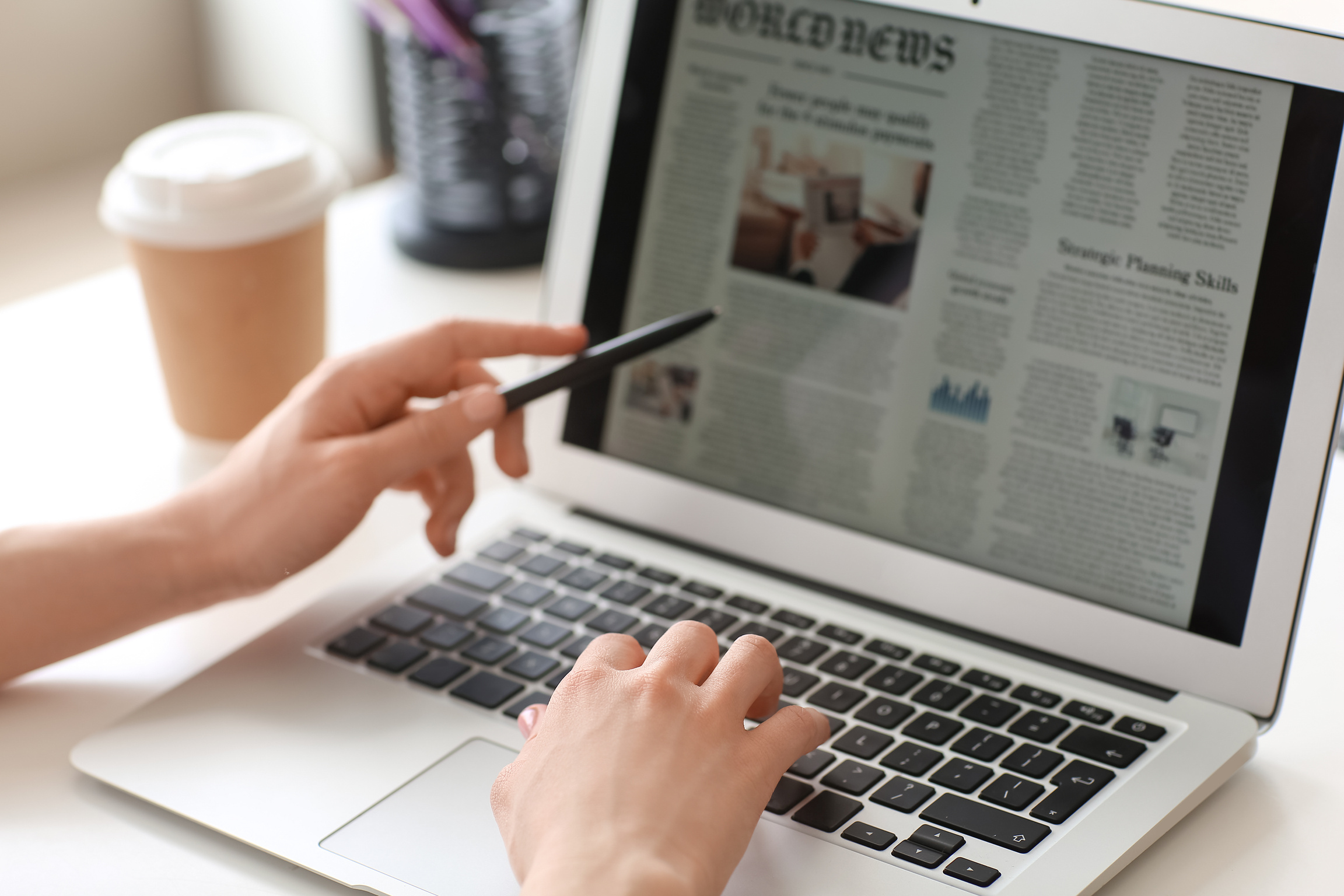 Young Woman Reading Newspaper Online at Home